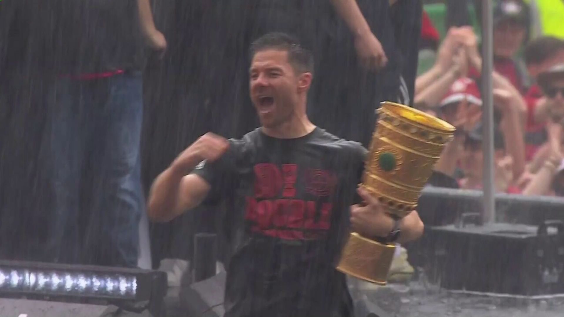 Leverkusen celebrate their unbeaten double in the rain!