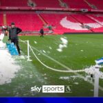 Sabotage!?!? Nev shovels snow onto Anfield pitch and Carra removes it!